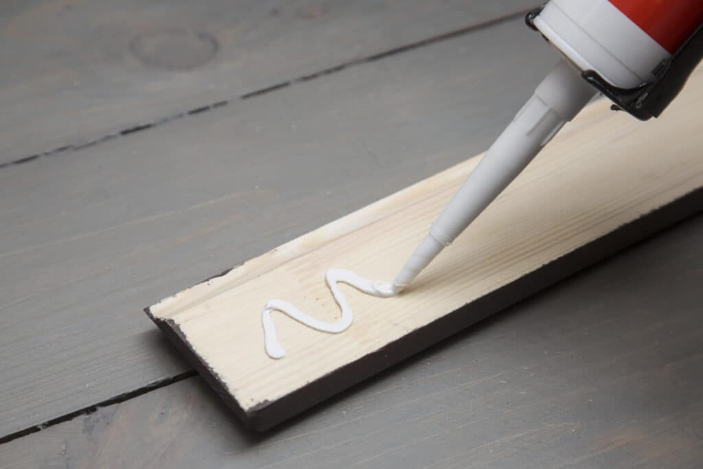 Adhesive being applied to construction.